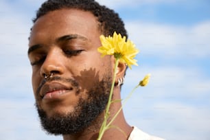 a man with a flower in his hair