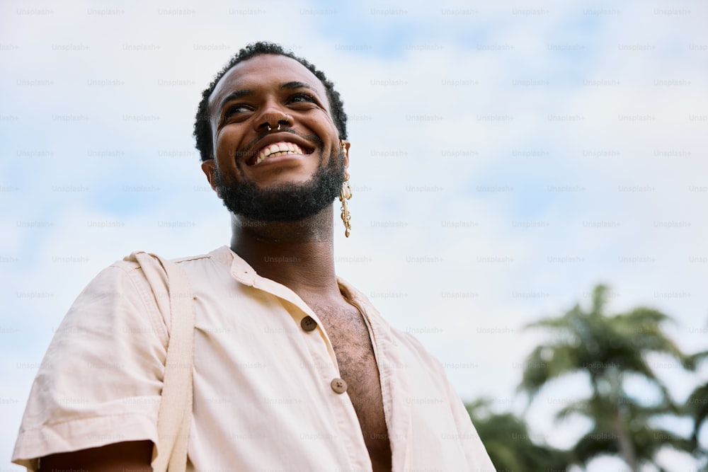 a man with dreadlocks smiles at the camera