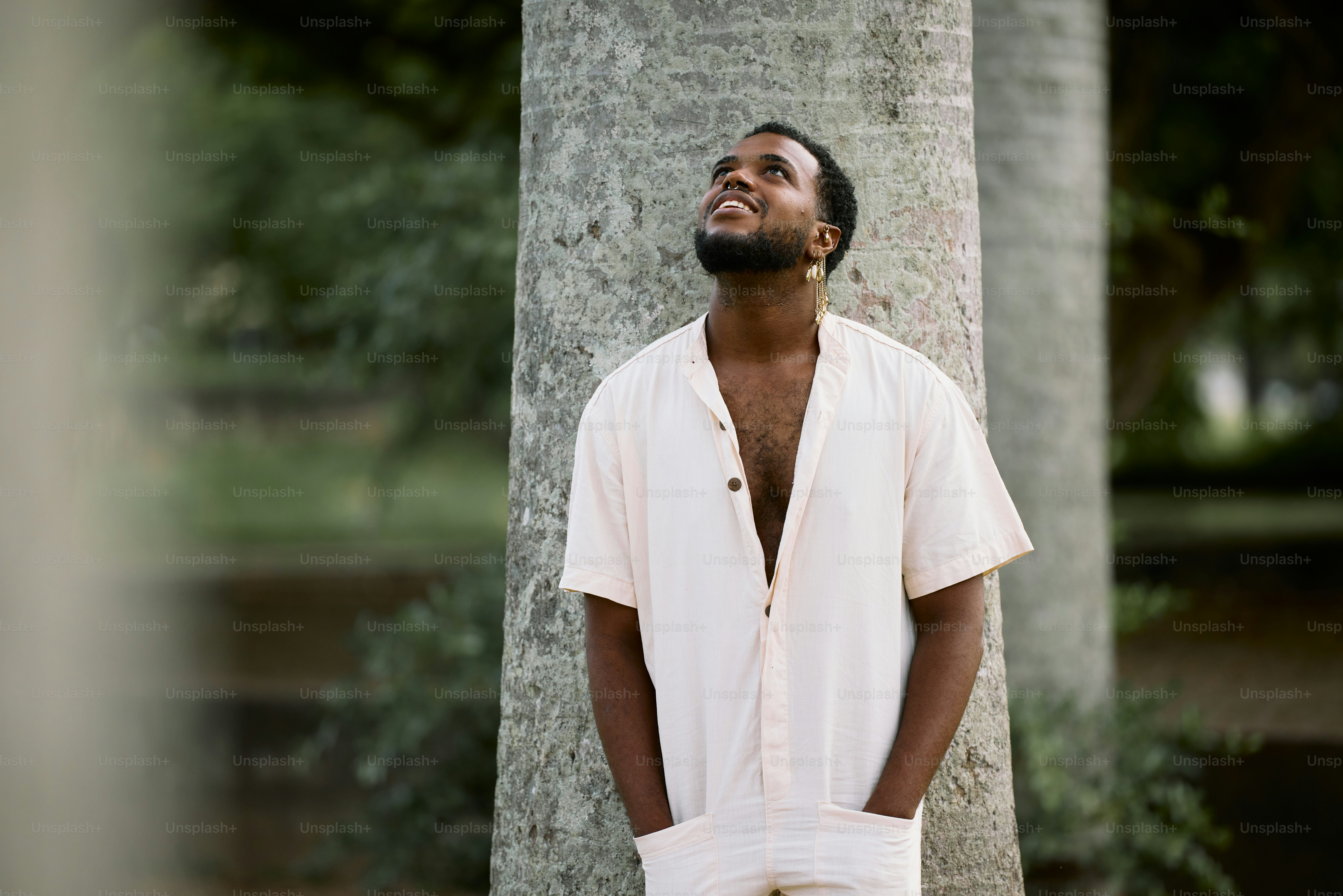 Ein Mann steht neben einem Baum in einem Park