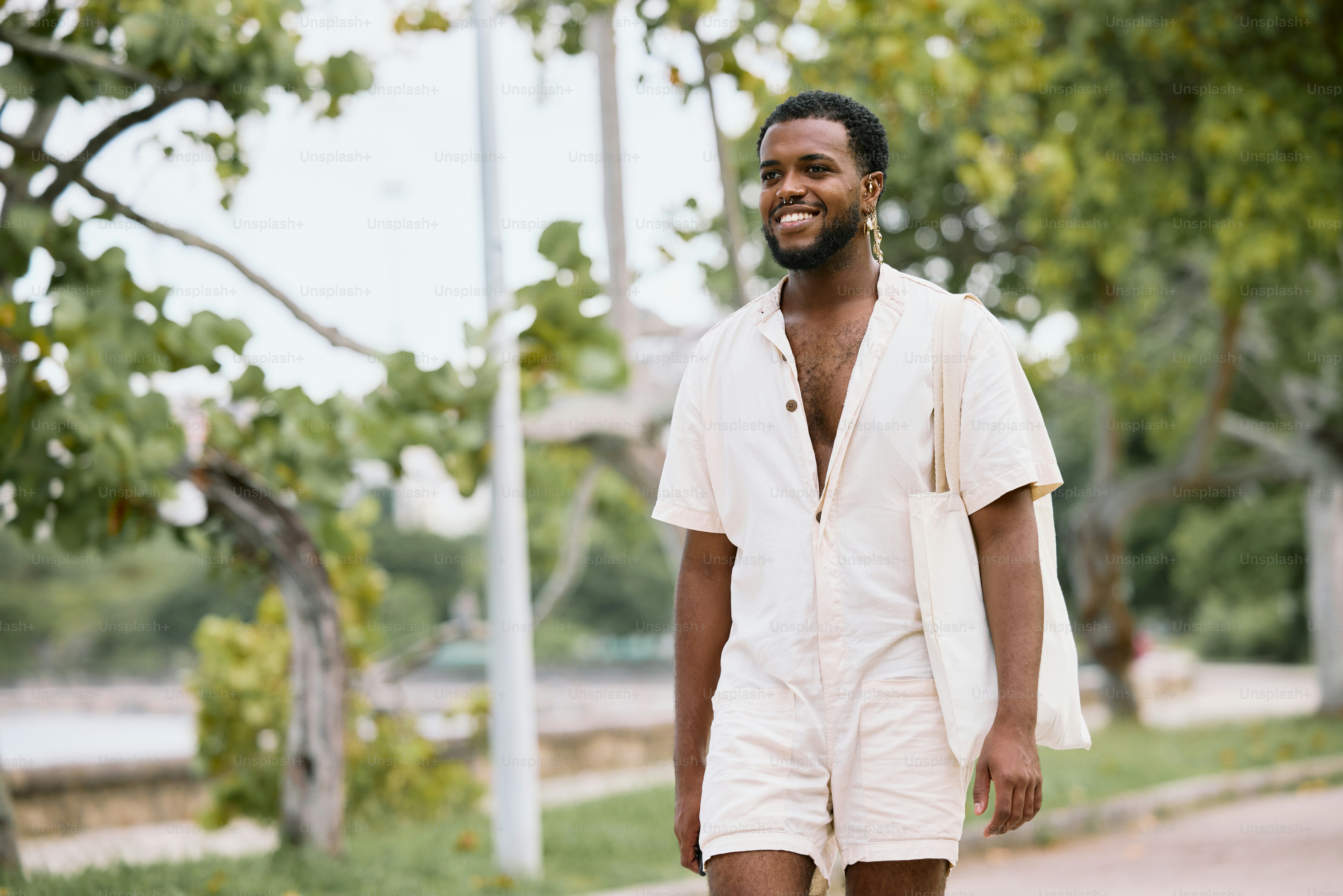a man in white is walking down the street