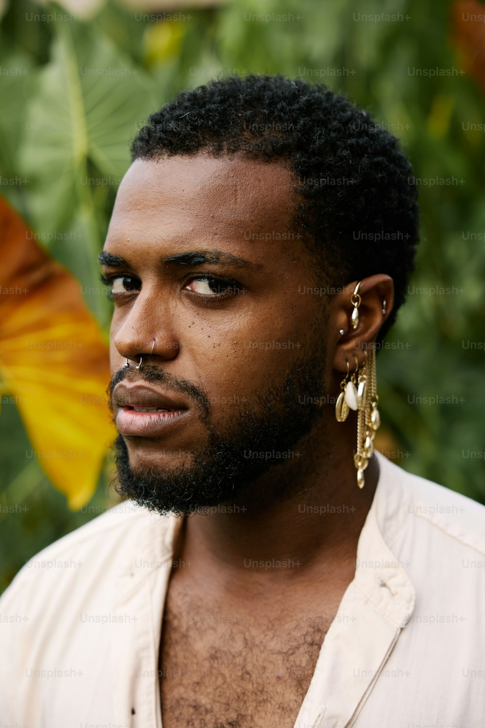 a close up of a person wearing a shirt and earrings