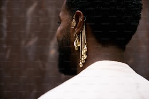 a man wearing a pair of gold earrings