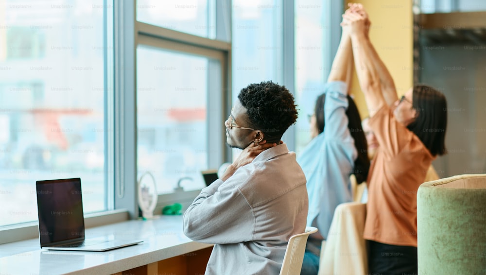 a group of people doing yoga in front of a window