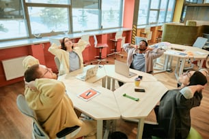 a group of people sitting around a table in a room