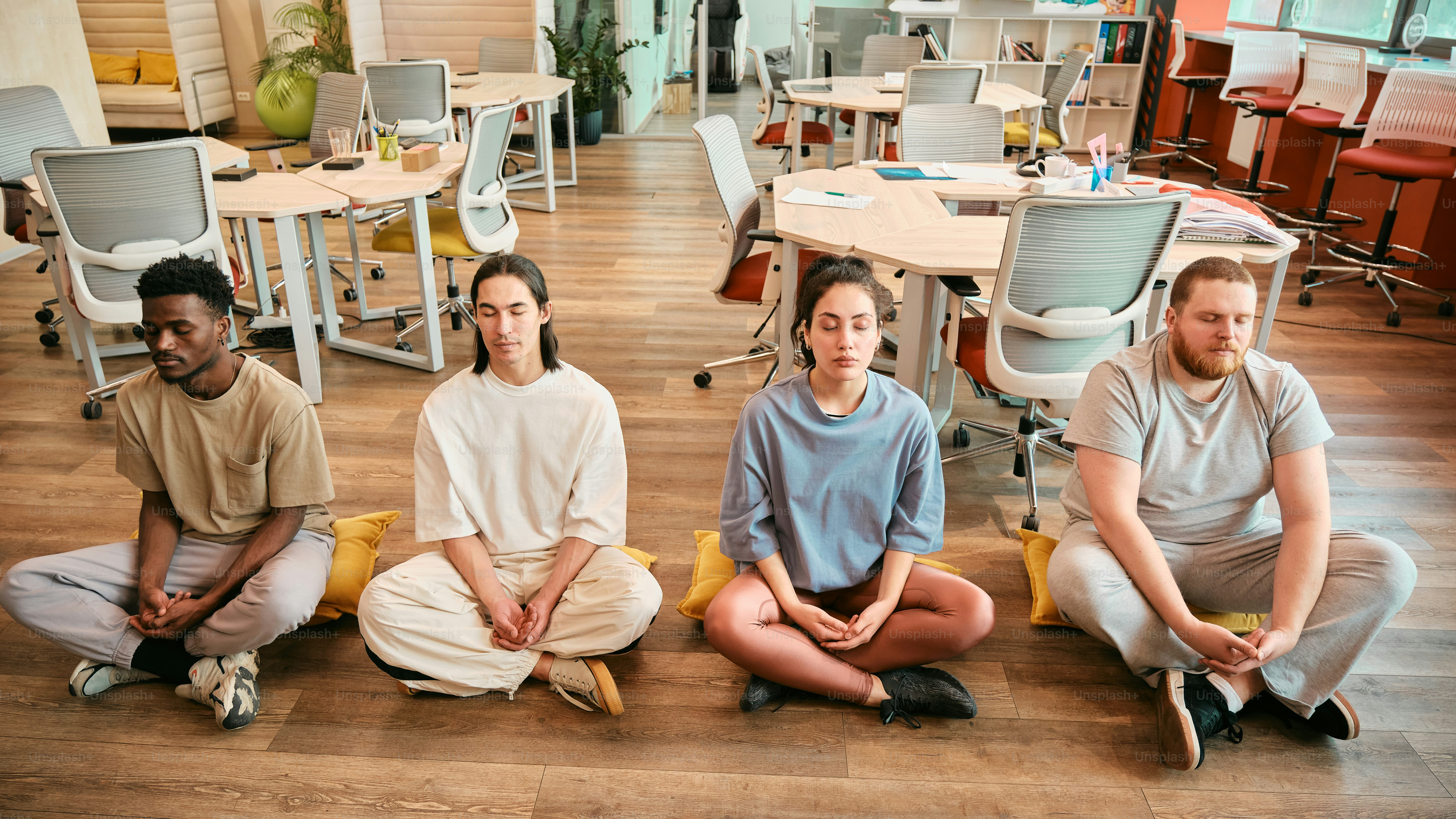 a group of people sitting on the floor in a room