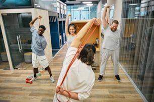a group of people in a gym doing exercises