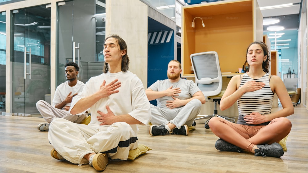 a group of people sitting on the floor in a room