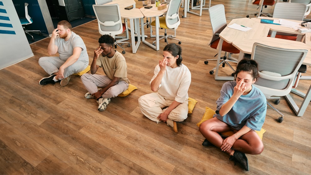 a group of people sitting on the floor in a room