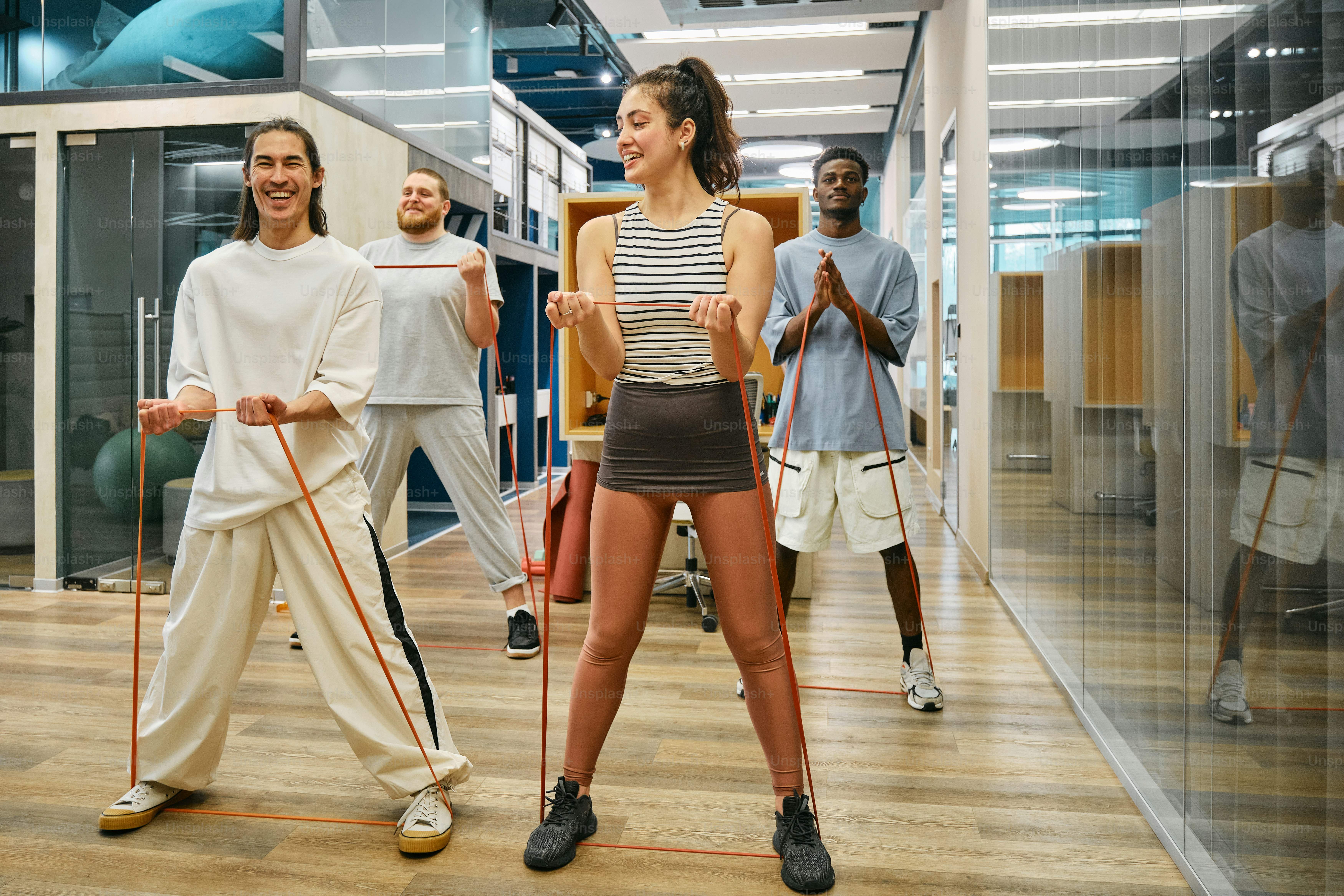 a group of people standing on top of a hard wood floor