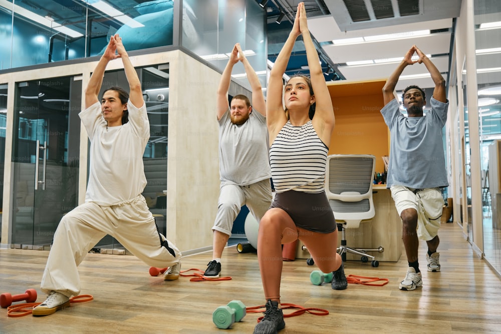 a group of people doing yoga in an office