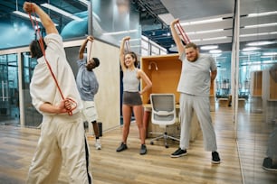 a group of people doing exercises in an office