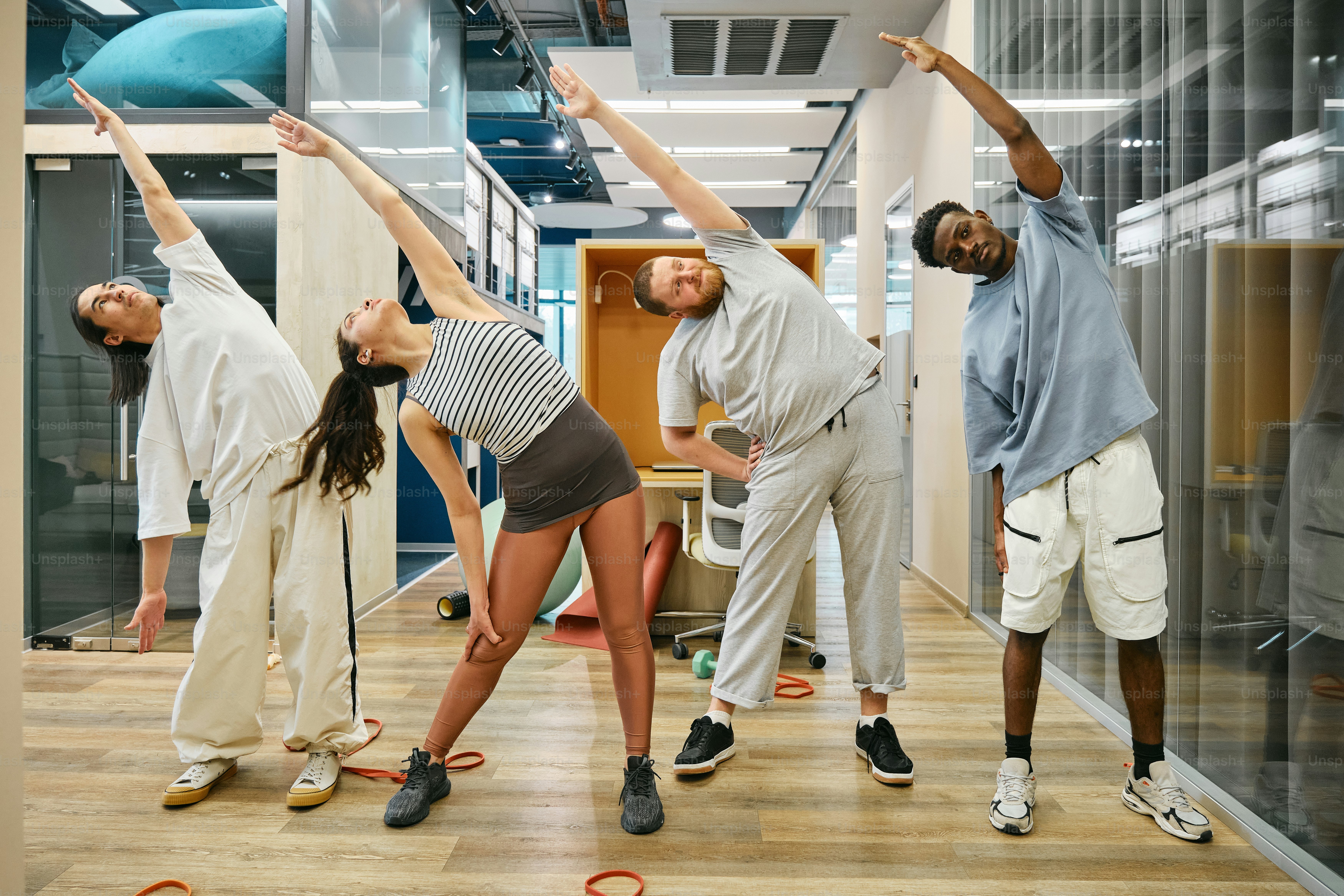 a group of people standing on top of a hard wood floor