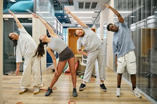 a group of people standing on top of a hard wood floor