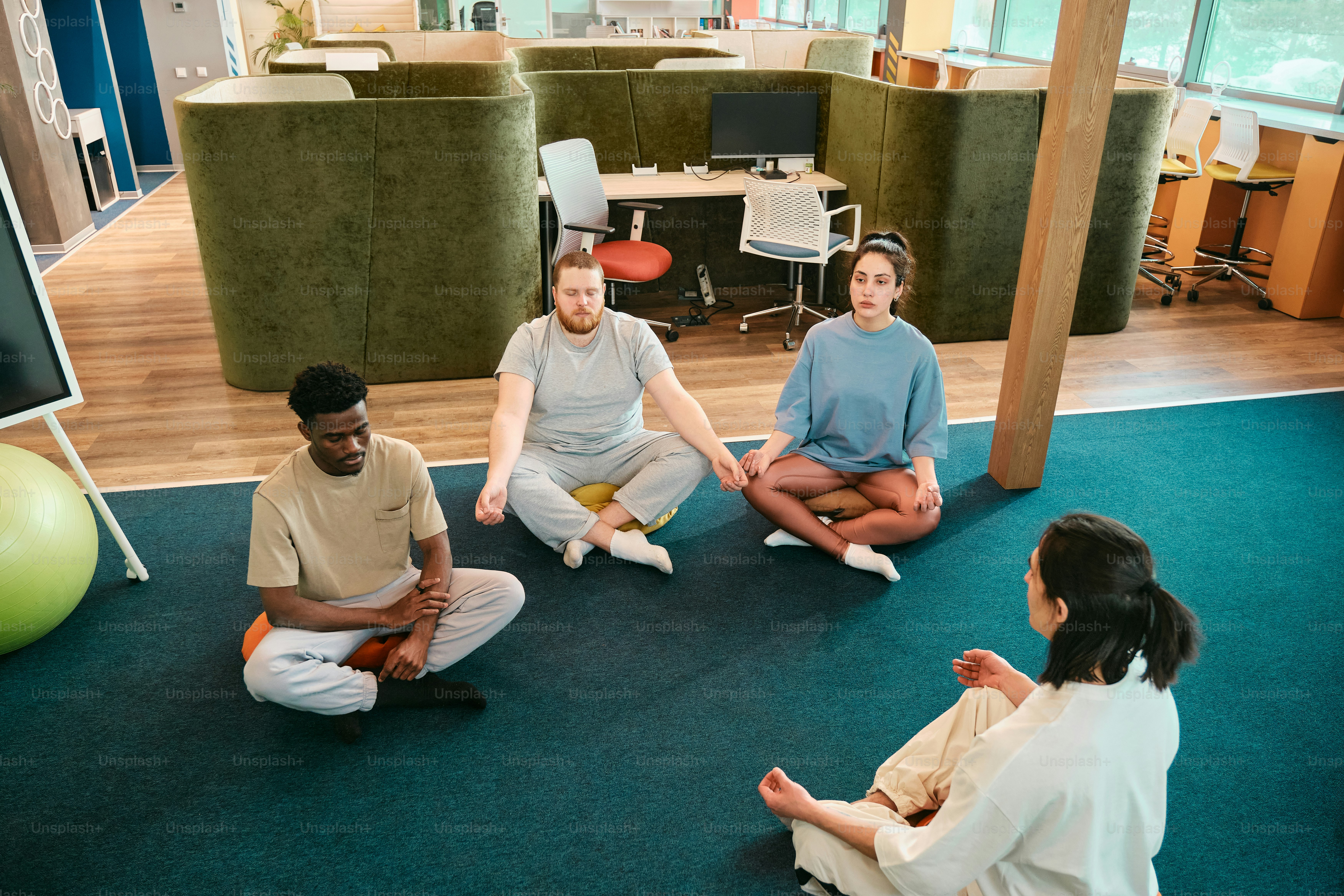 a group of people sitting on the floor in a circle