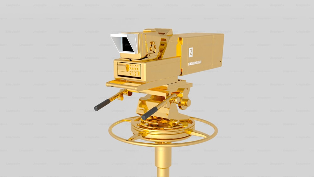 a gold object with a camera on top of it