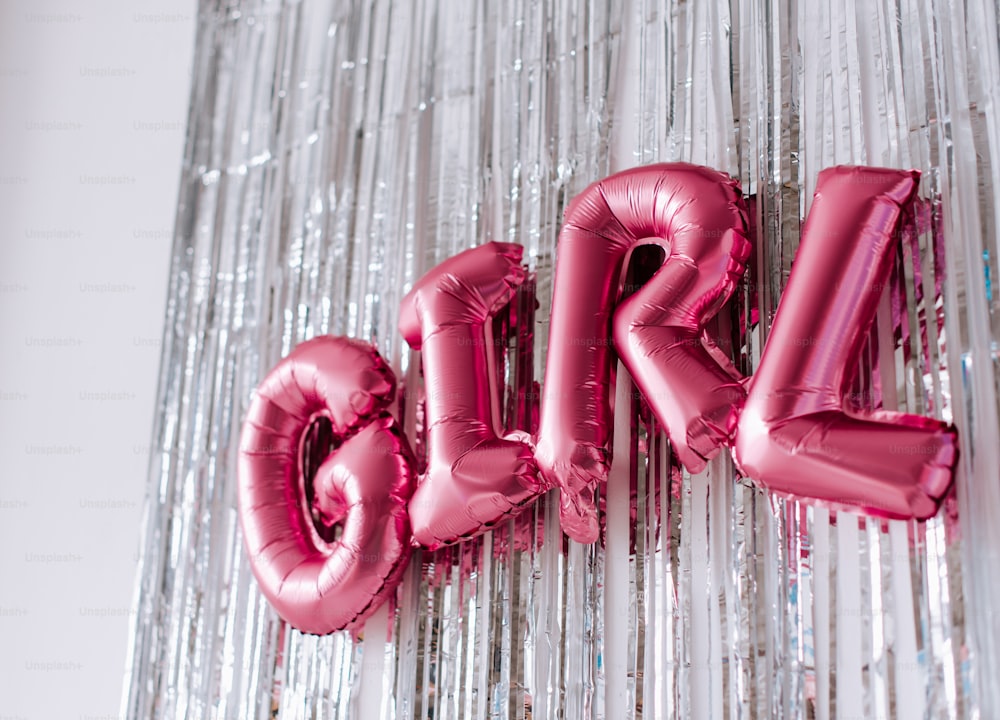 the word girl spelled out of pink balloons