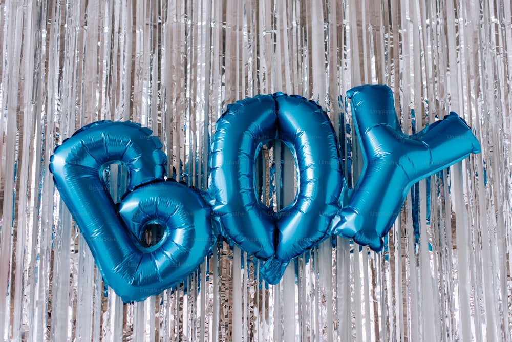 blue balloons spelling out the word boo on a silver background