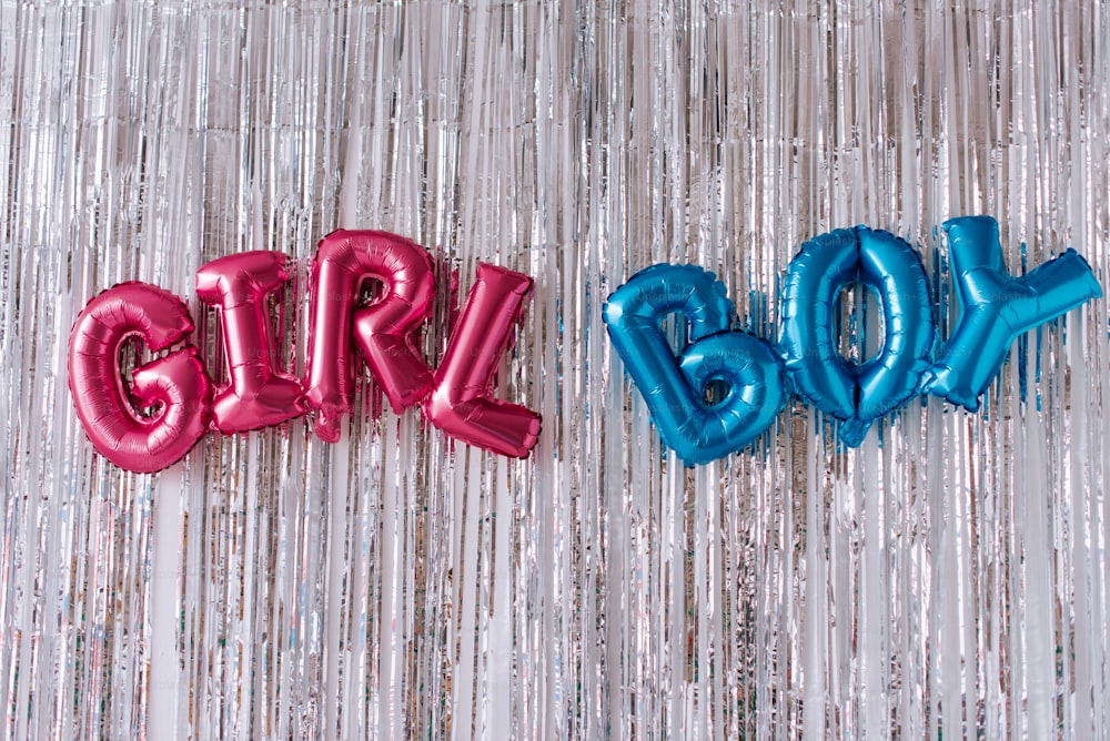 two balloons that spell out the word girl and boy