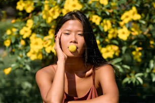 a woman with a yellow ball in her mouth