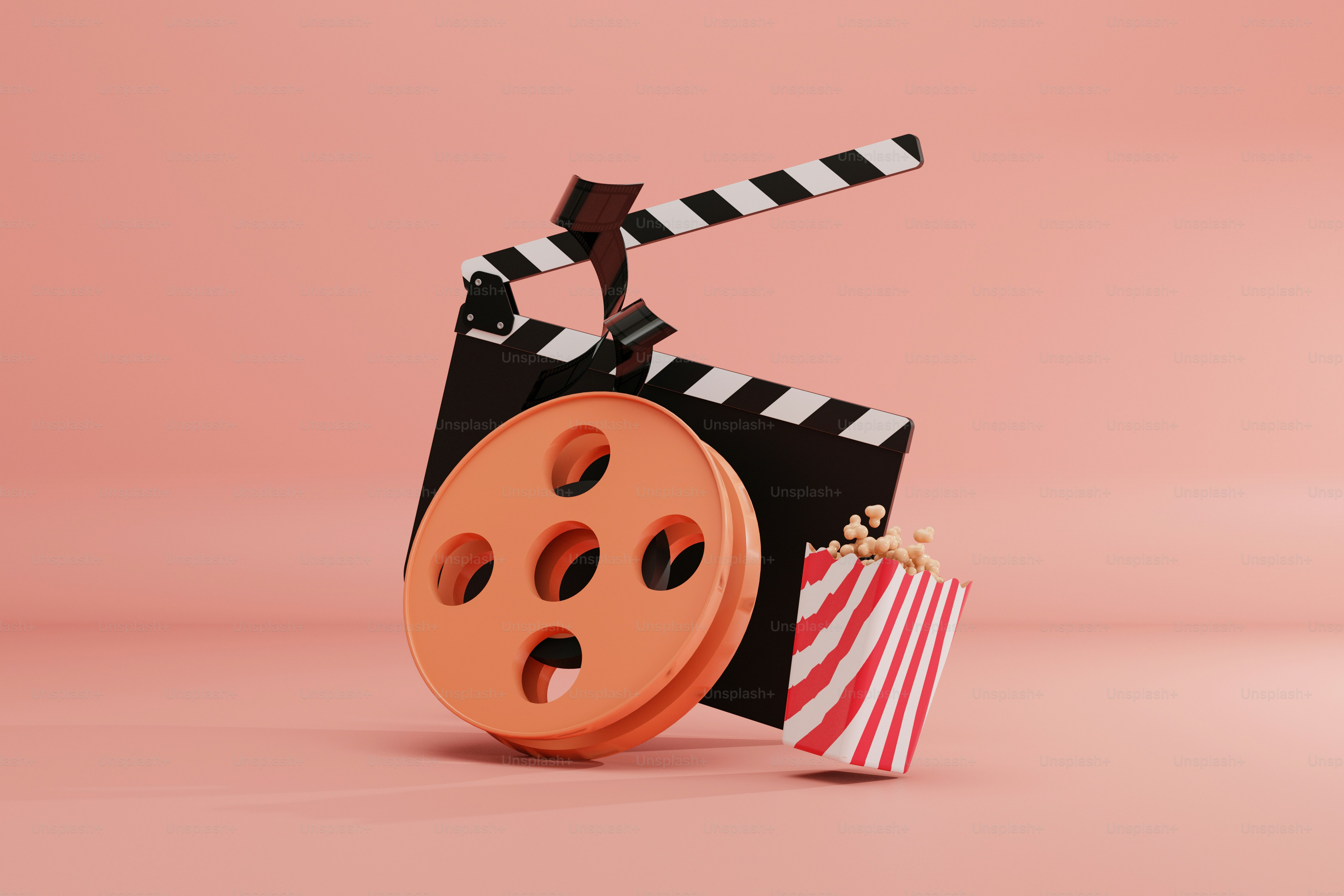 a film reel and a bag of popcorn on a pink background