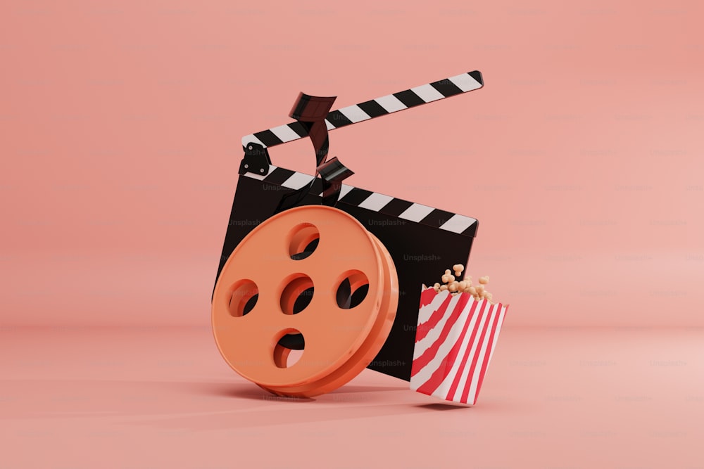 a film reel and a bag of popcorn on a pink background