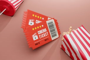 a red and white striped bag of popcorn next to a red and white striped bag