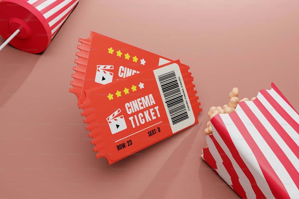 a red and white striped bag of popcorn next to a red and white striped bag
