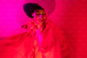 a woman in a red light room with her hair blowing in the wind