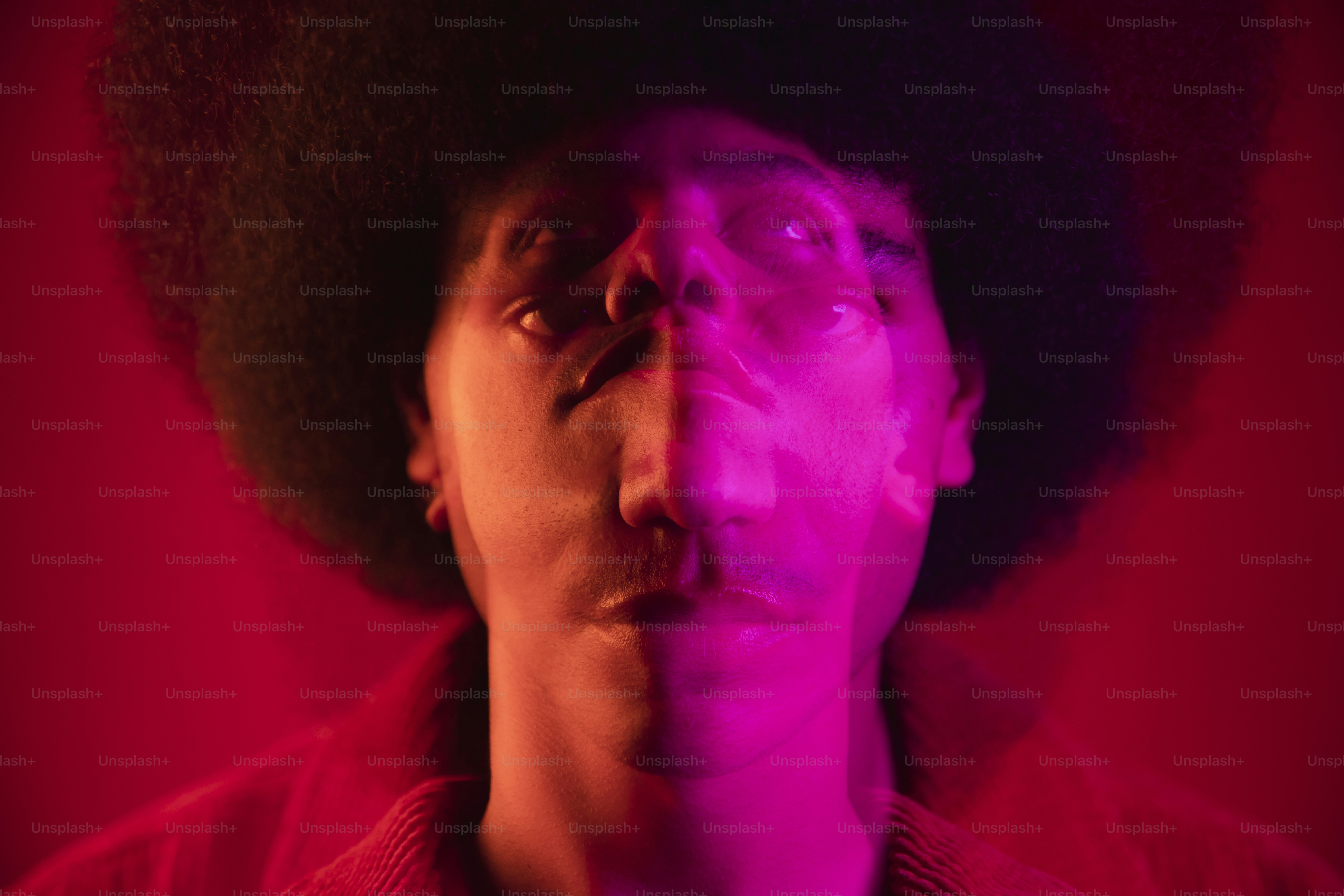 ein Mann mit Afro und rotem Hintergrund