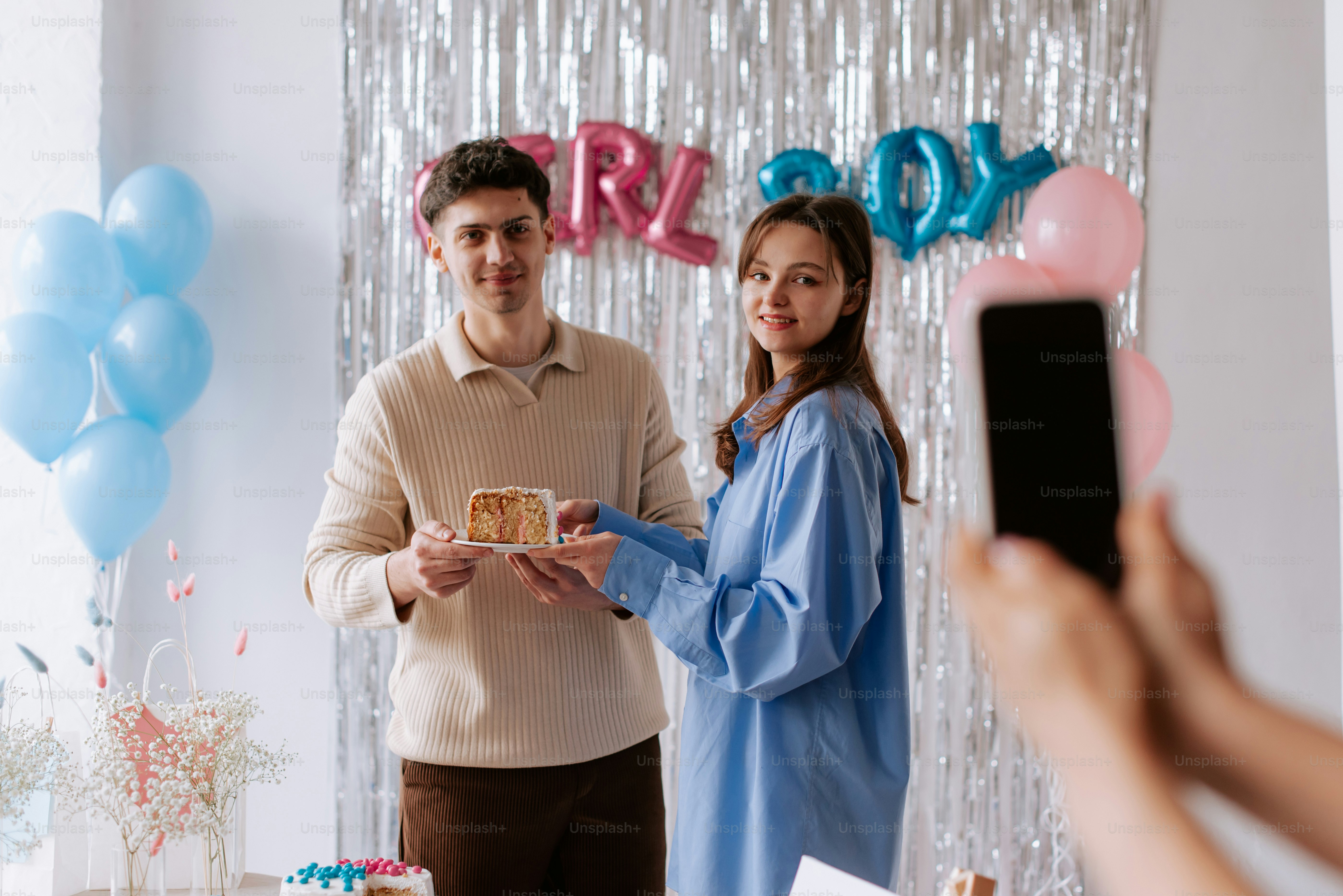 a man and a woman standing in front of a cake