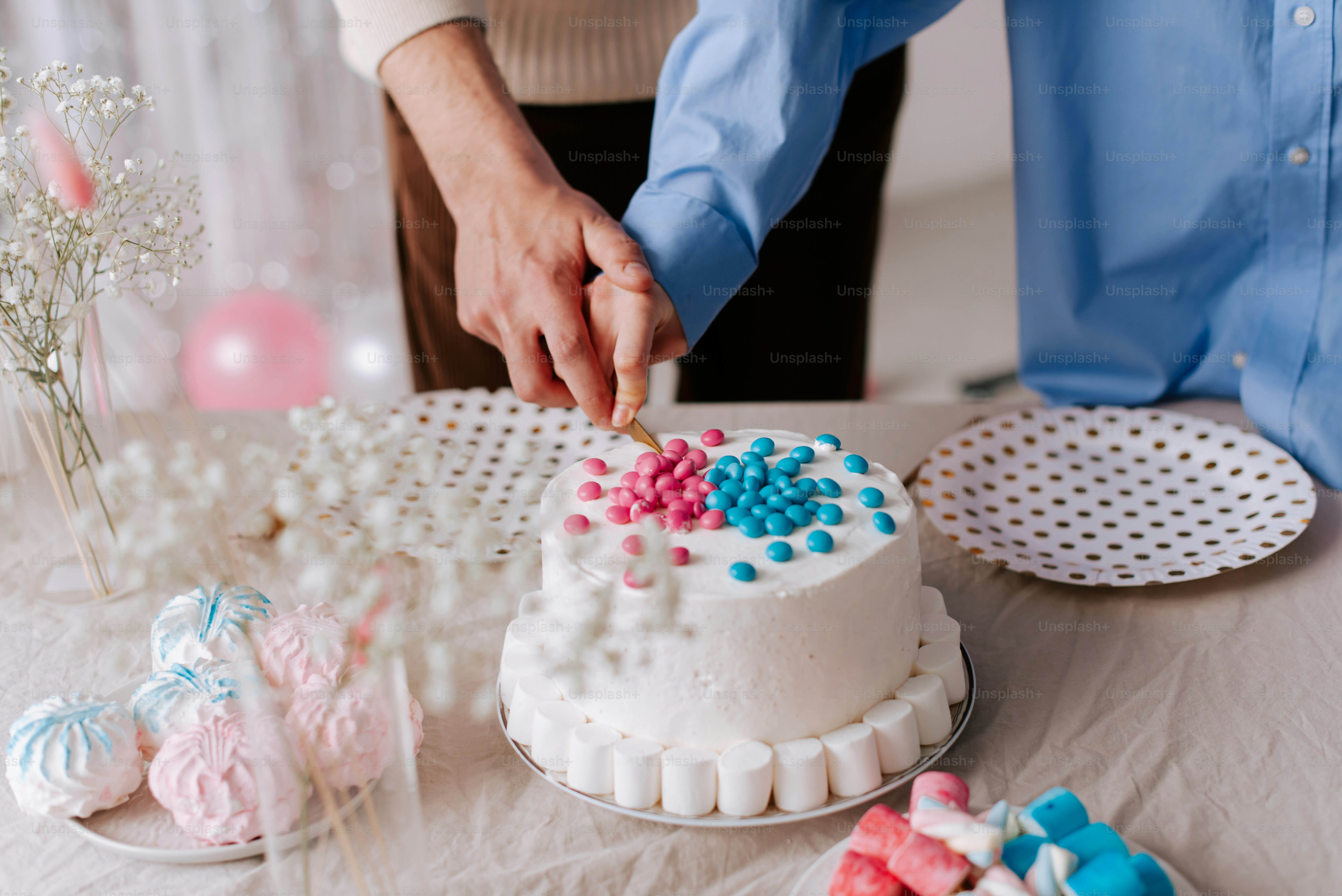 a person cutting a cake with a knife