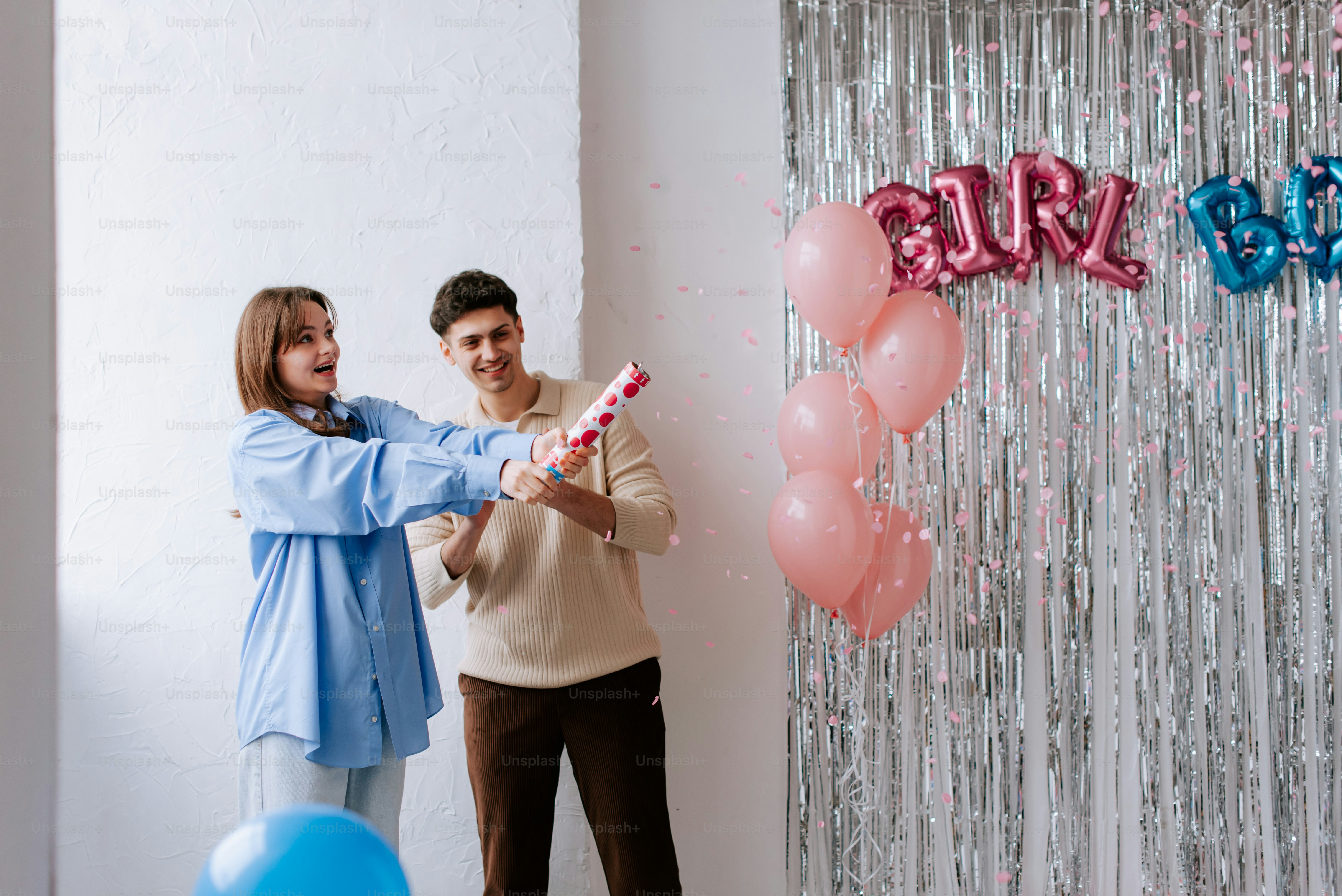 a man and a woman holding a birthday cake
