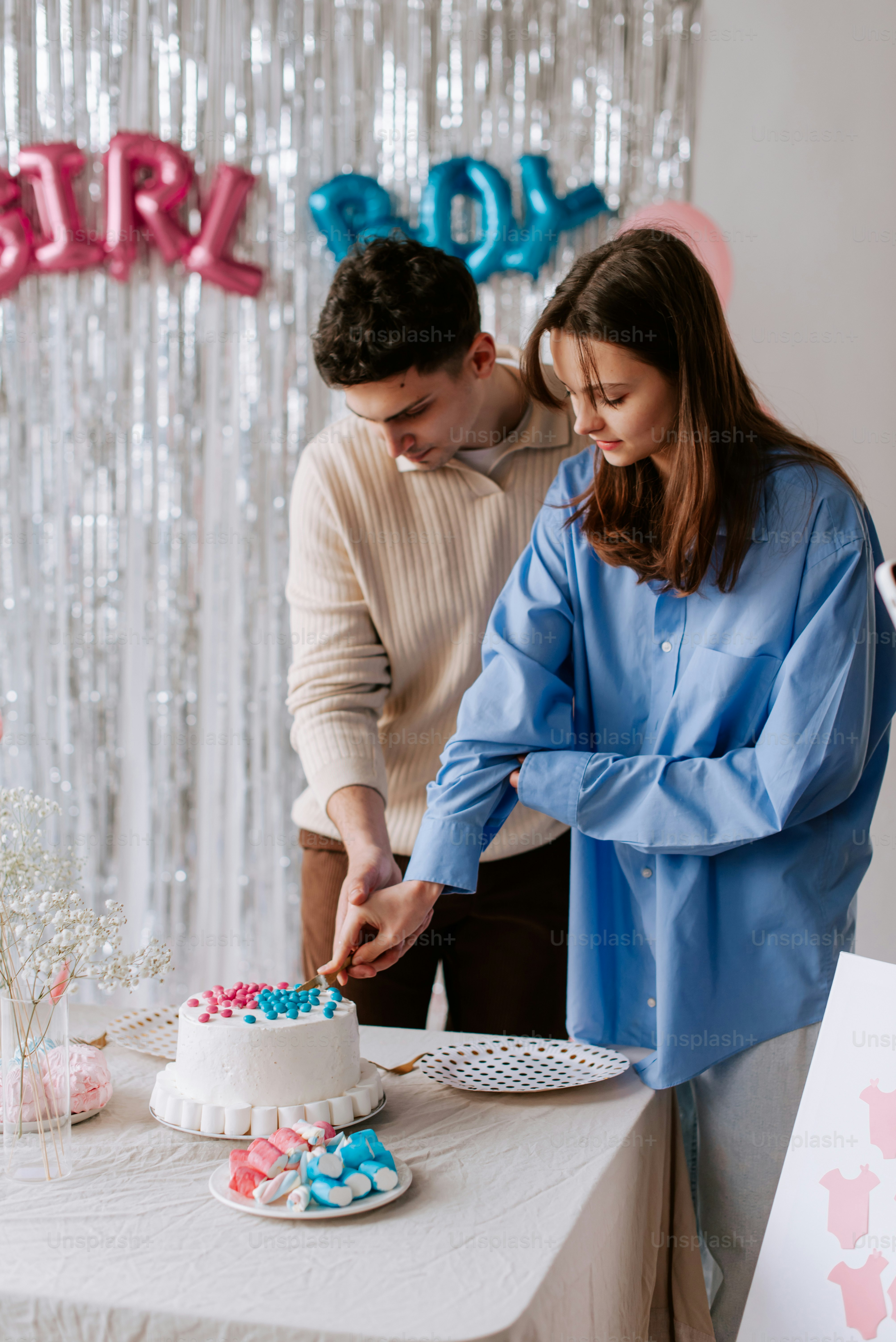 a man and woman cutting a cake together