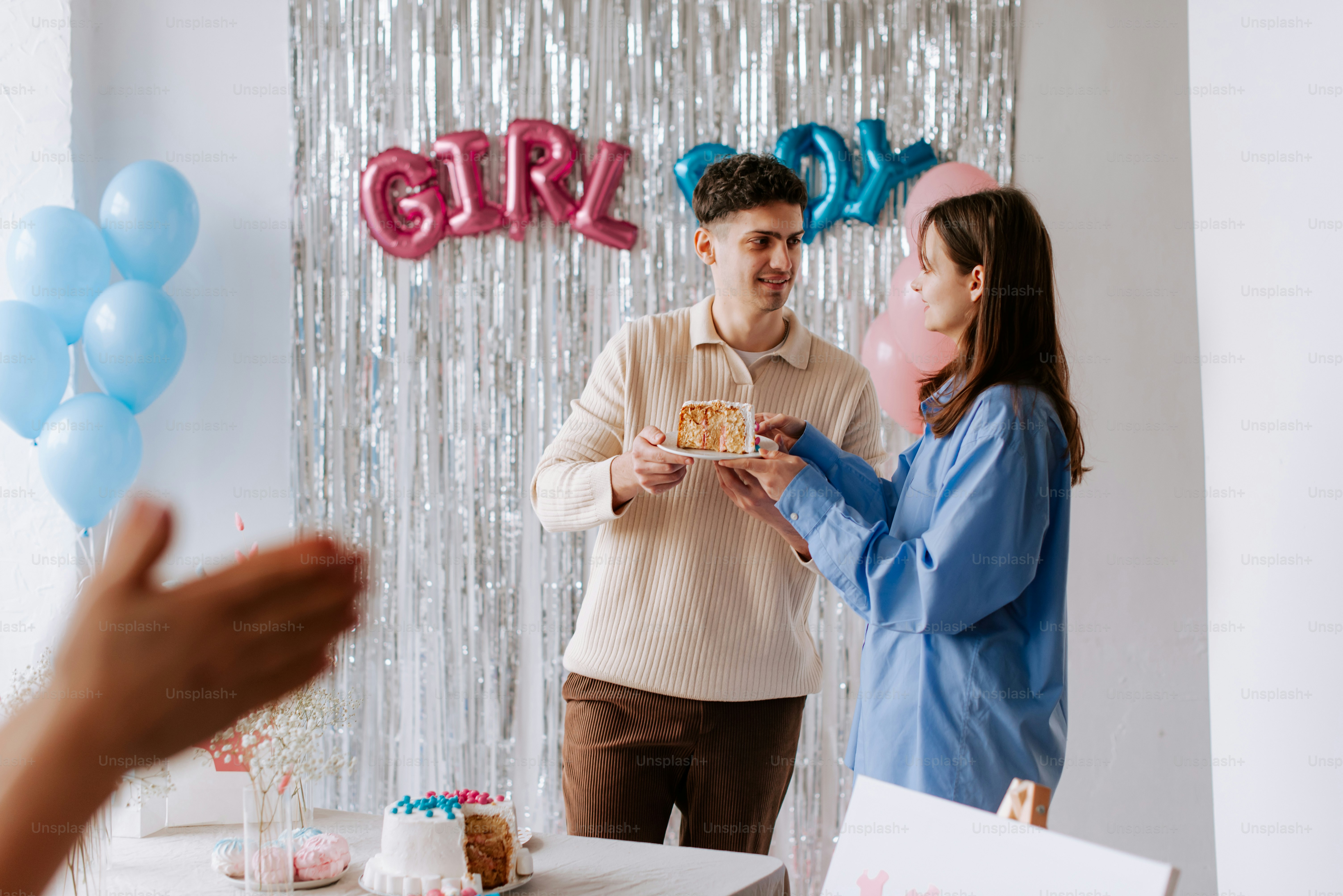 a man and a woman standing in front of a cake