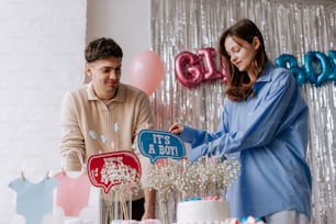 a man and woman cutting a cake together