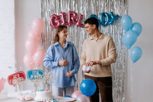 a man and a woman standing in front of a cake