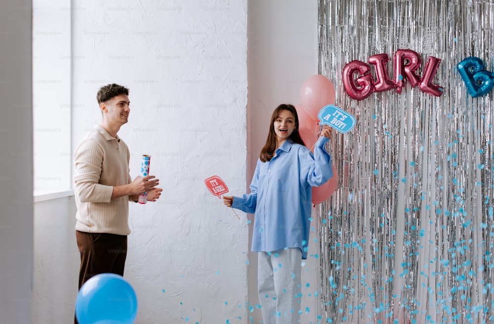 a man and a woman are holding up balloons