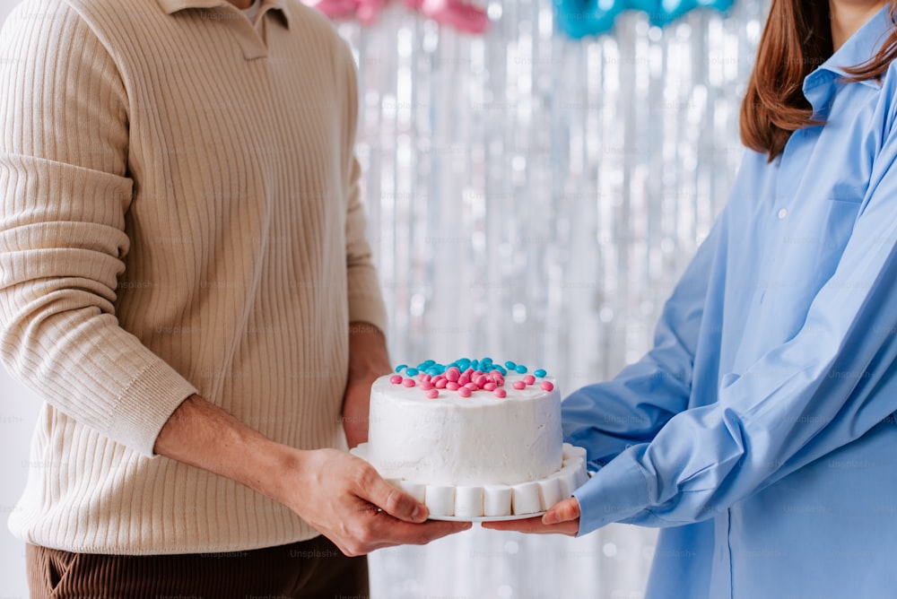 a man and a woman holding a cake