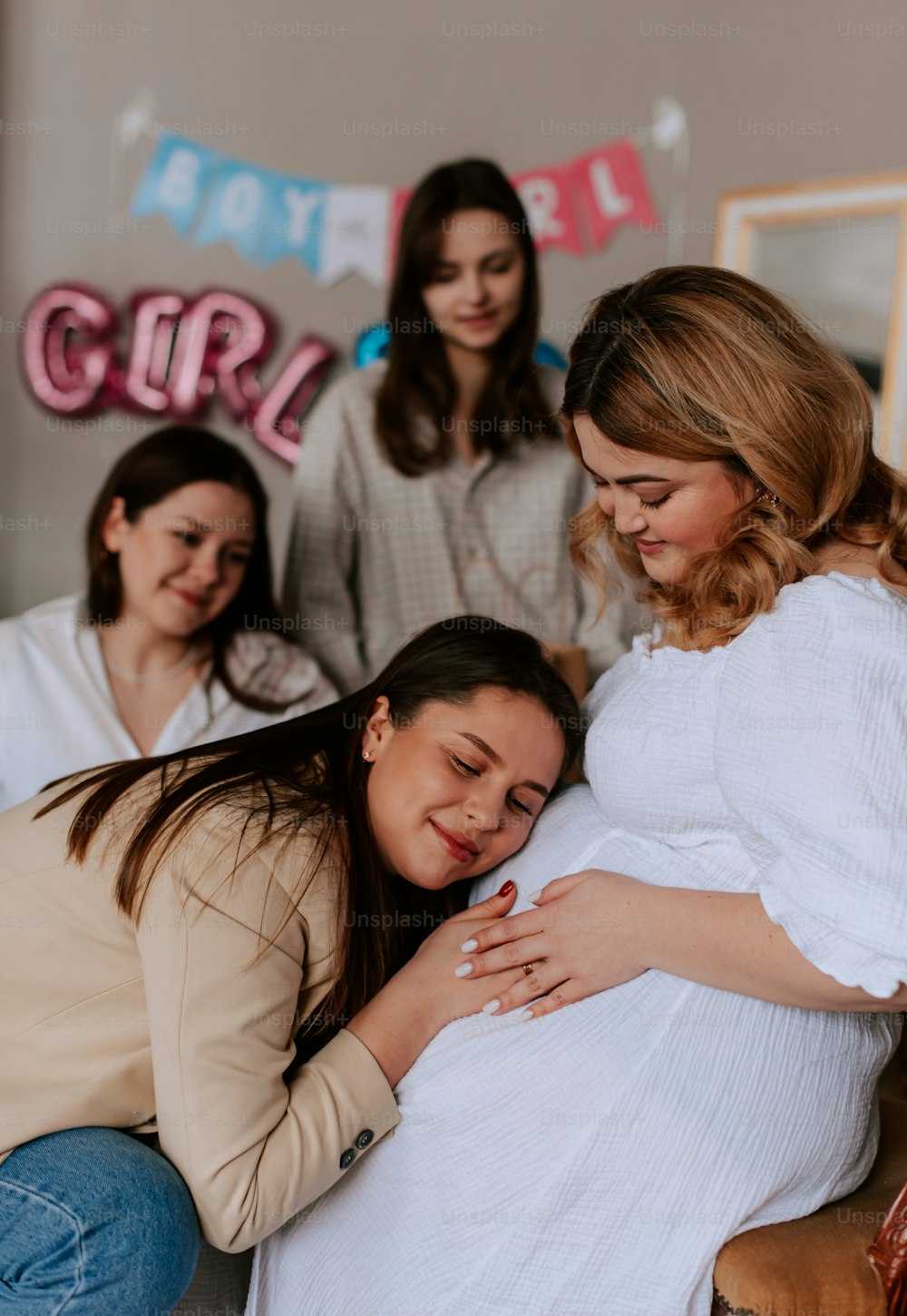 a group of women standing around a pregnant woman