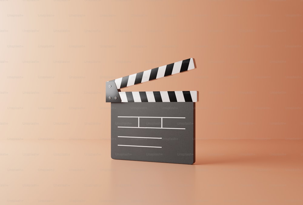 a movie clapper on a pink background