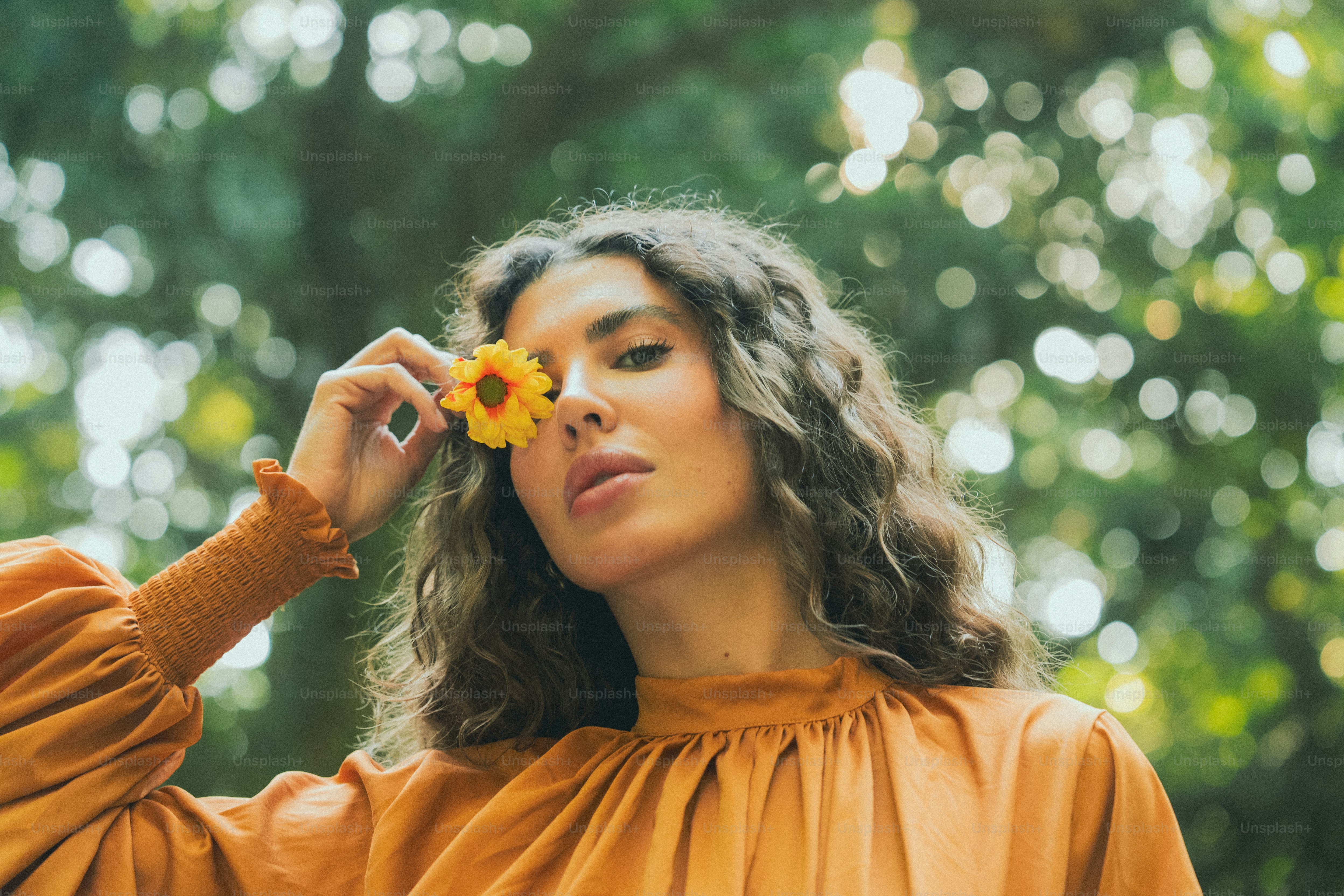 A woman with a flower in her hand photo – Spring Image on Unsplash