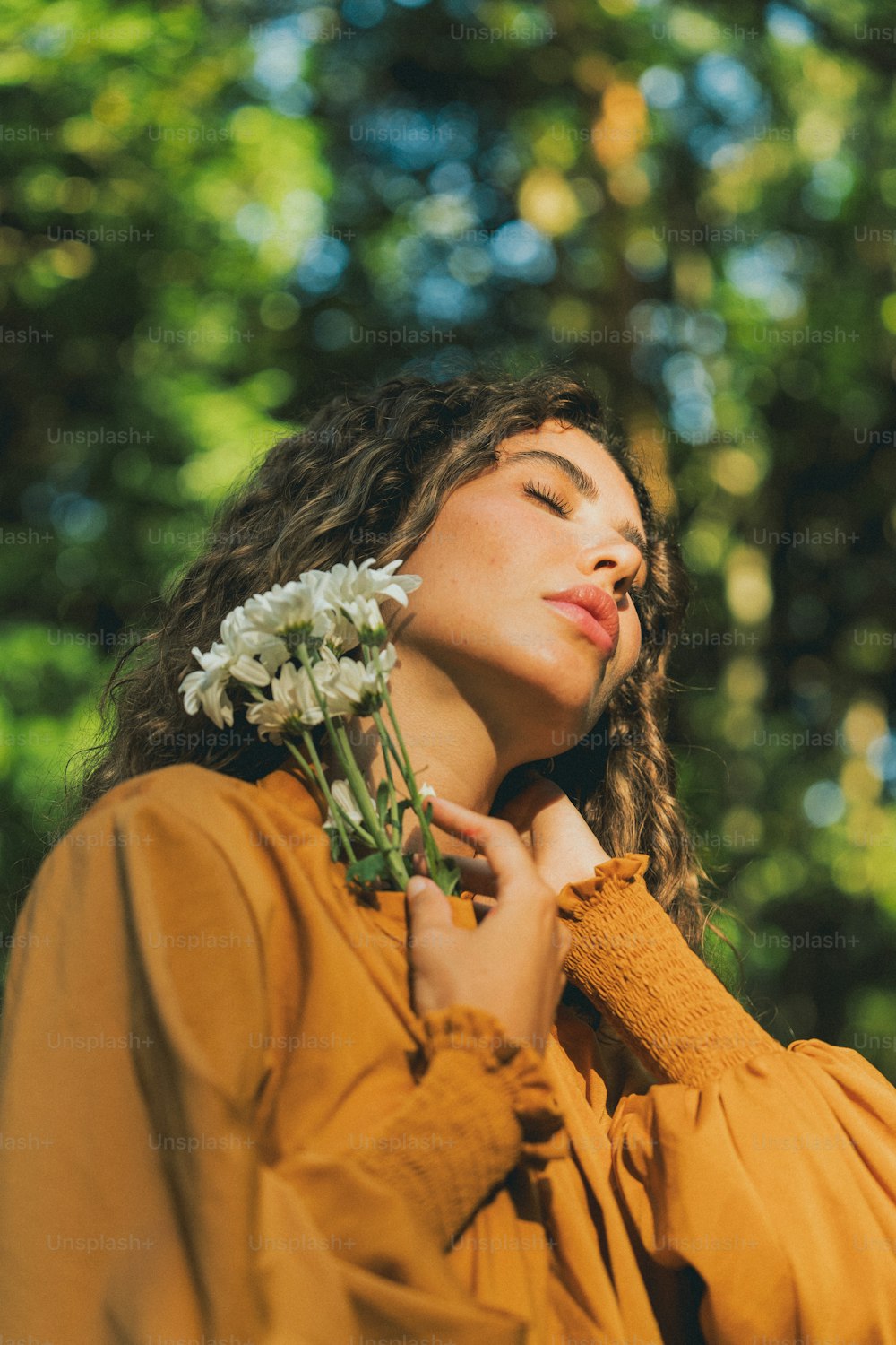 a woman holding a flower in her hand