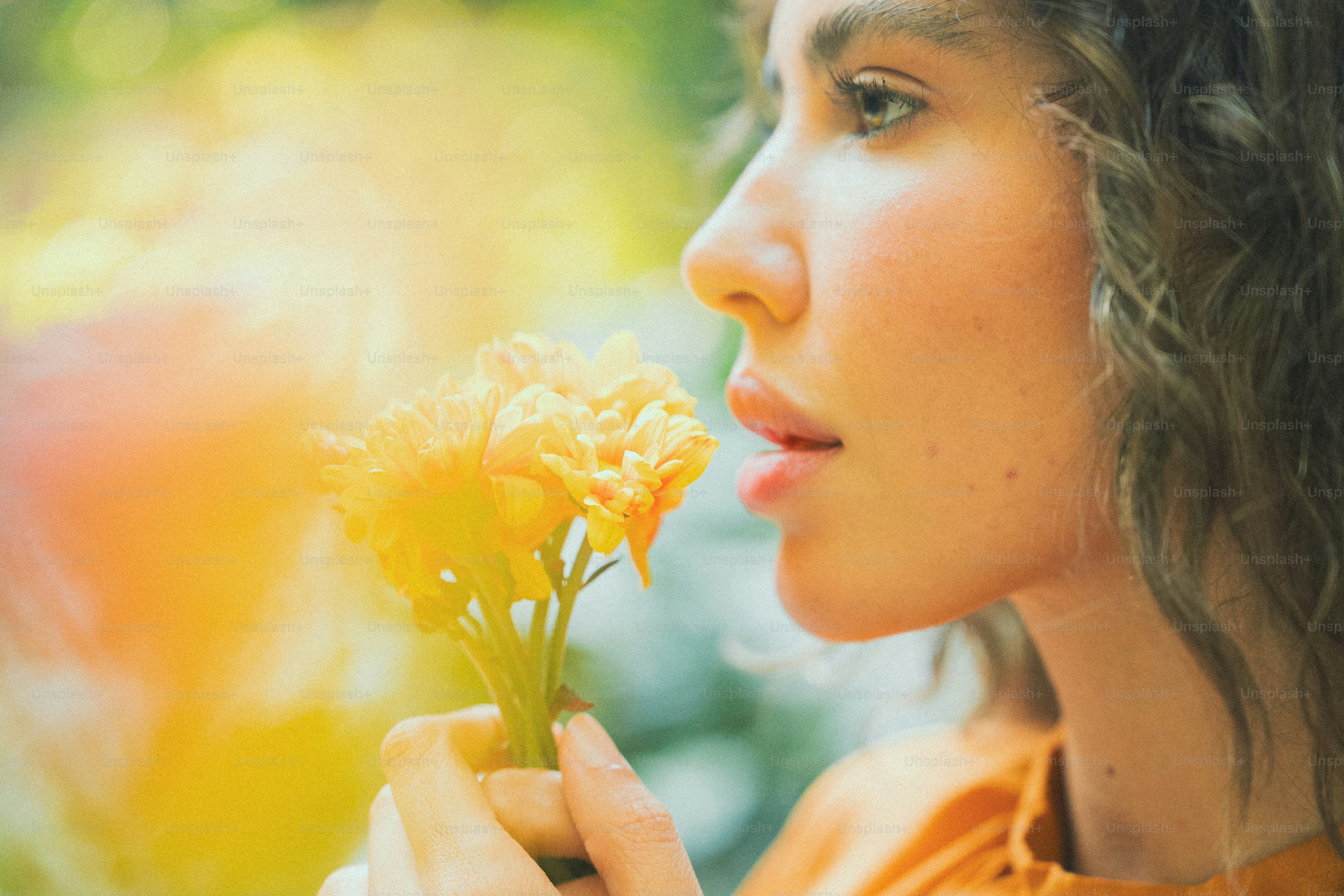 A woman holding a yellow flower in her hand photo – Spring Image on ...