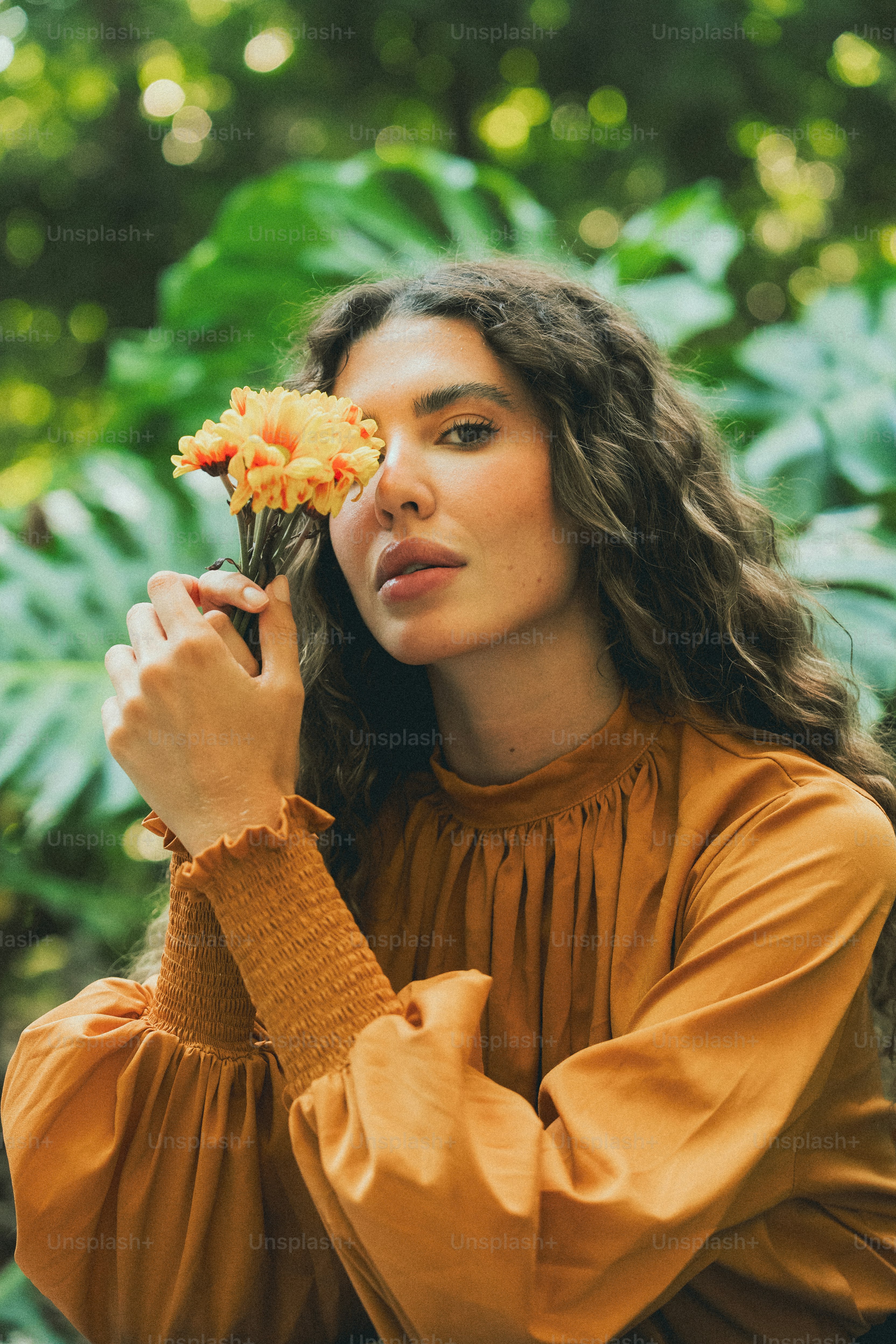 A woman holding a flower in her hand photo – Flowers Image on Unsplash