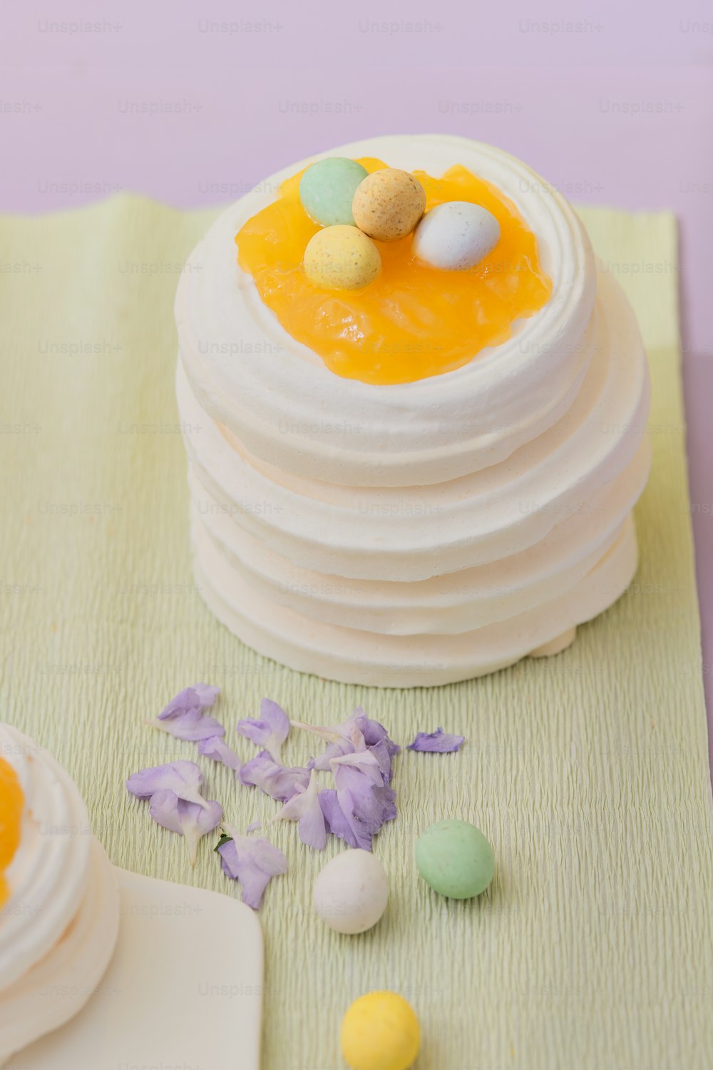 a white cake with yellow icing and eggs on top