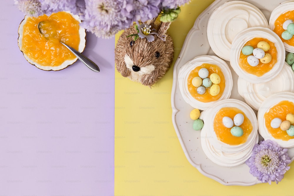 a plate topped with cupcakes next to a stuffed animal