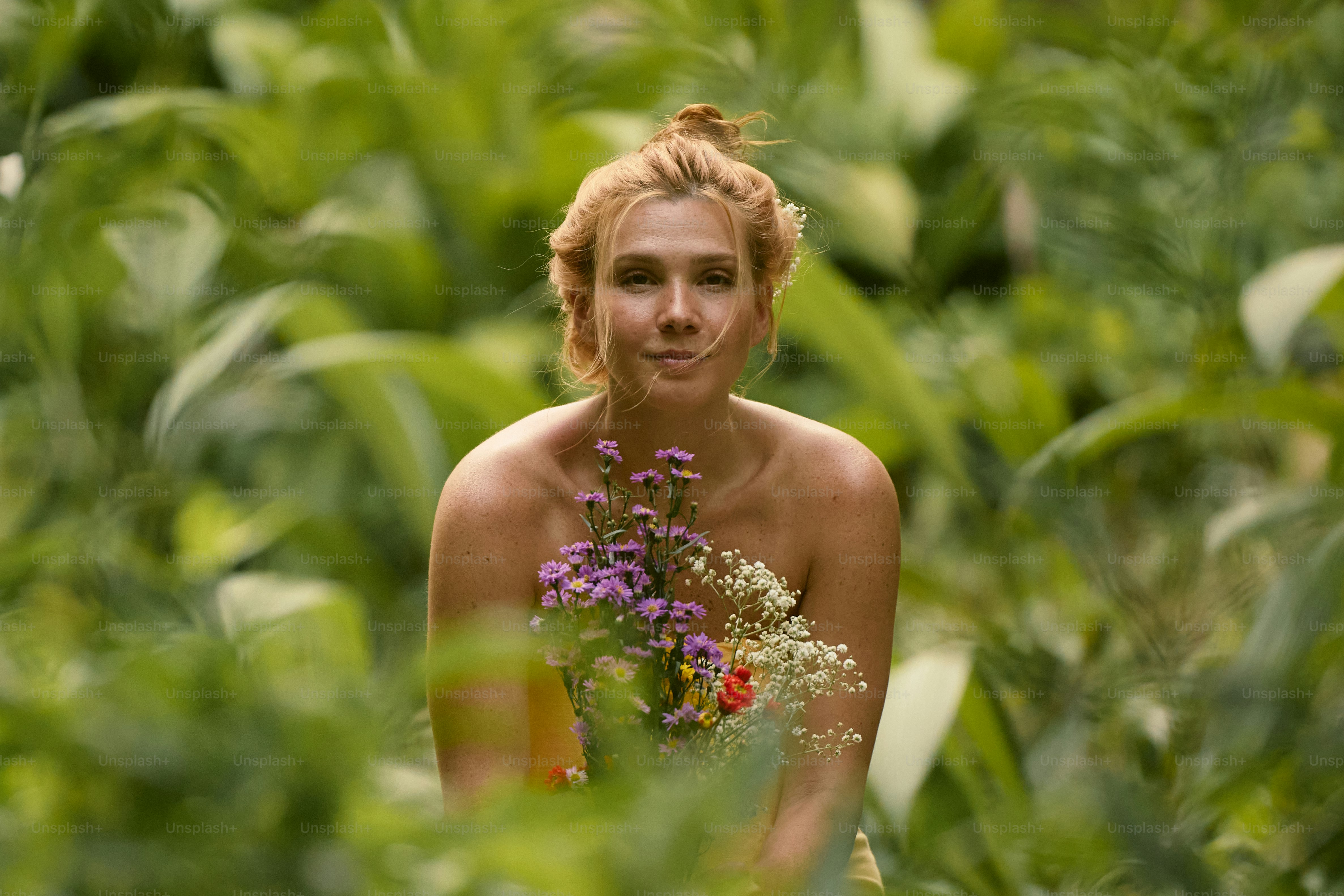 A woman with a bunch of flowers on her head photo – Flowers Image on ...