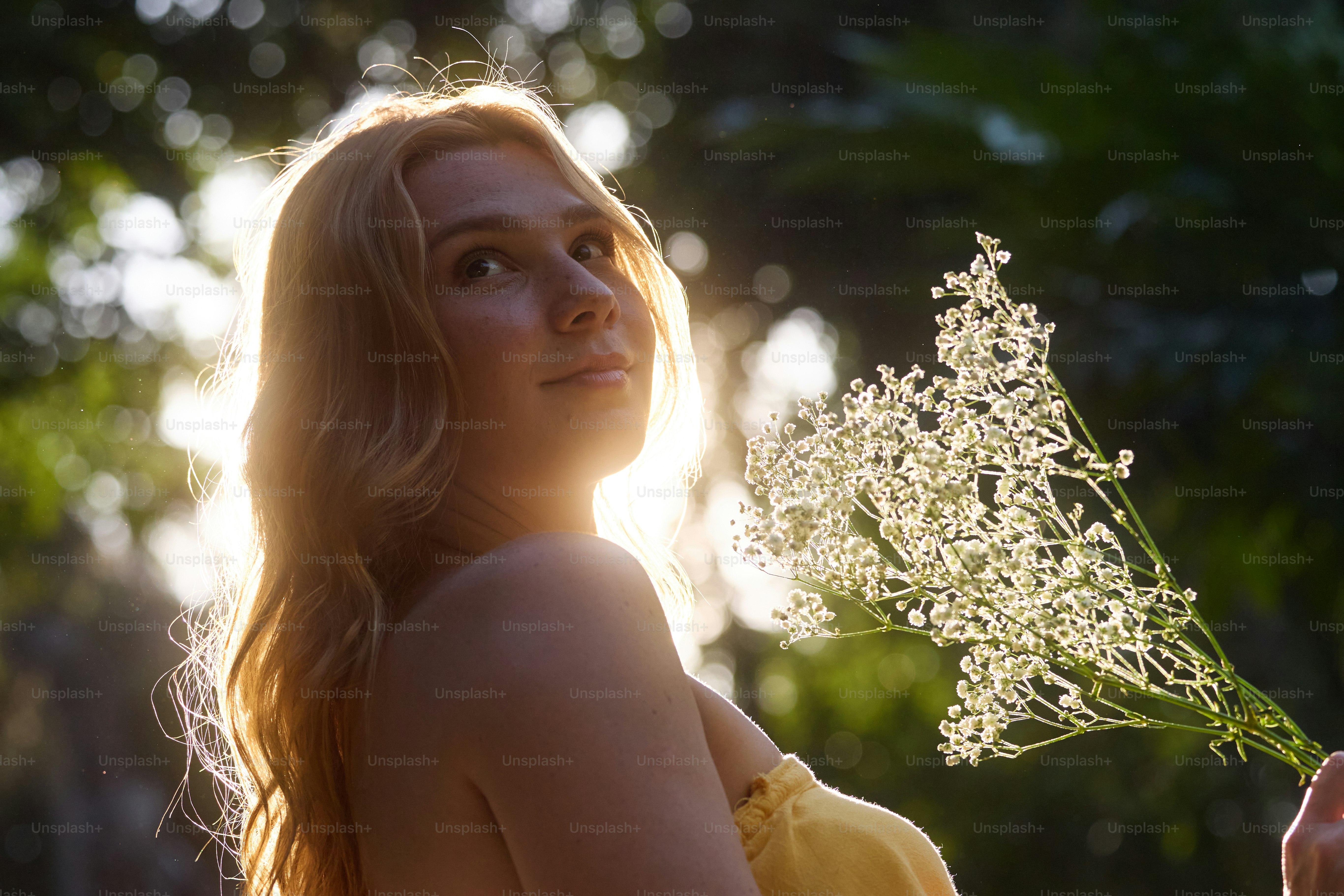 A woman in a yellow dress holding red flowers photo – Flowers Image on ...