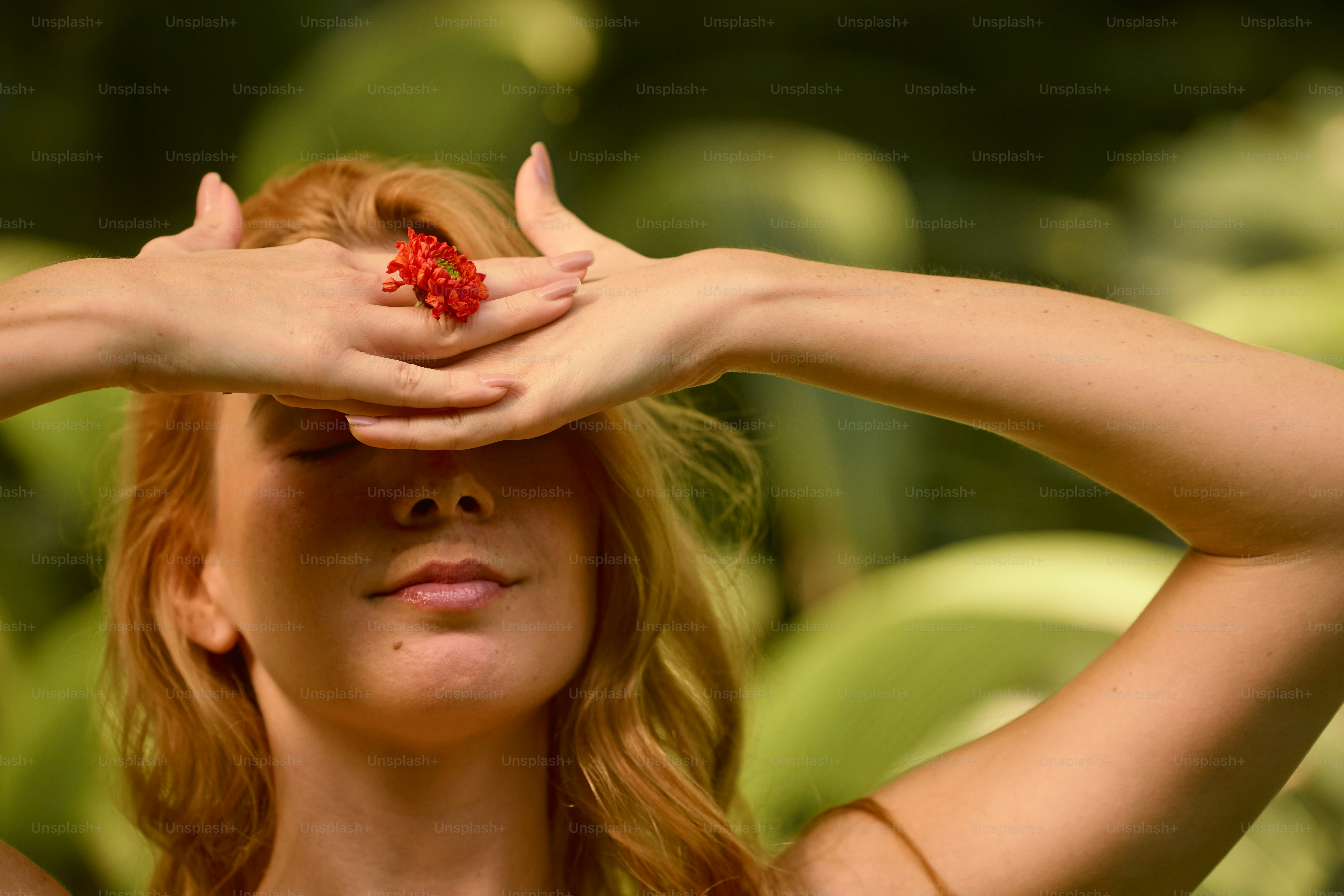 A woman with her eyes closed and a bouquet of flowers in front of her ...