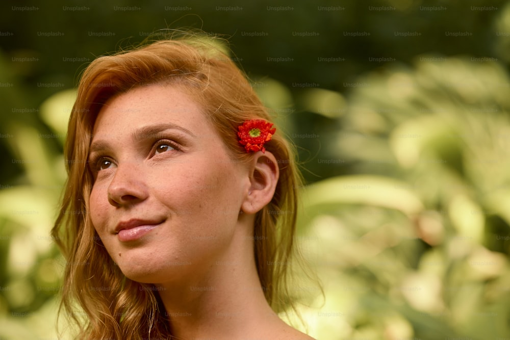 a woman with a red flower in her hair